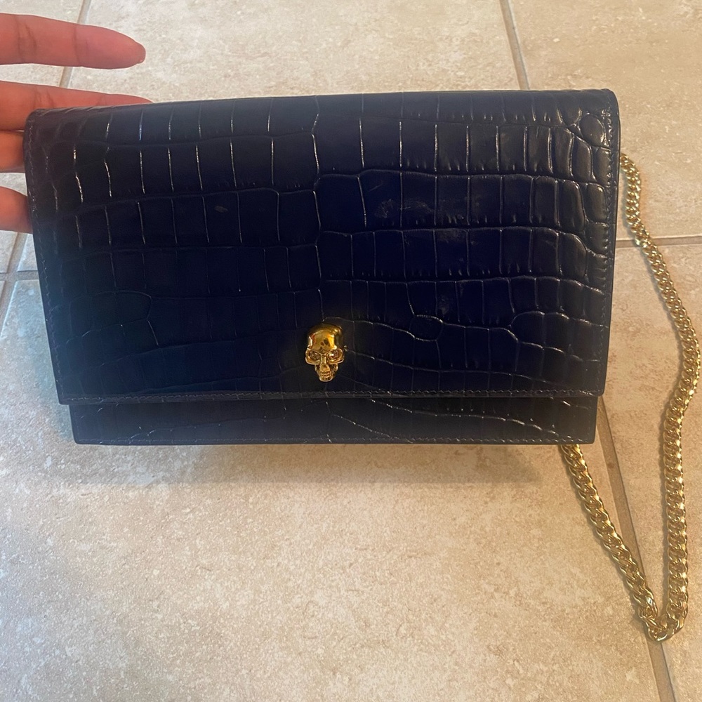 Dark blue croc skin Alexander McQueen evening bag with gold hardware.